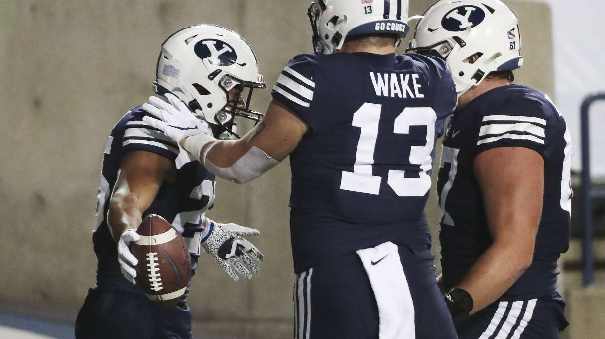 Brigham Young Cougars running back Tyler Allgeier (25) celebrates his touchdown against Texas State with Brigham Young Cougars tight end Masen Wake (13) in Provo on Saturday, Oct. 24, 2020.