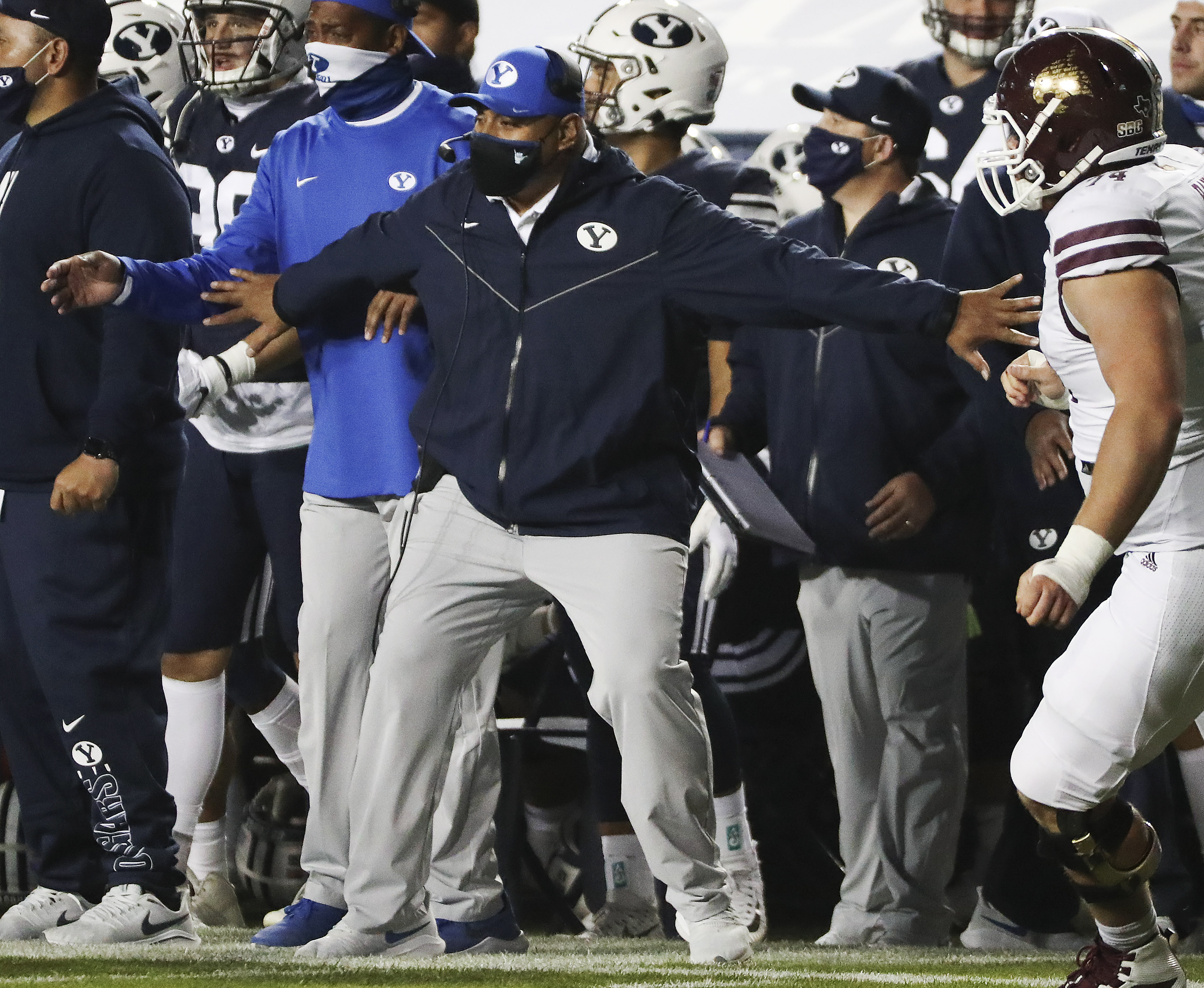 Brigham Young Cougars head coach Kalani Sitake holds his players back after an interception for a touchdown  in Provo on Saturday, Oct. 24, 2020.