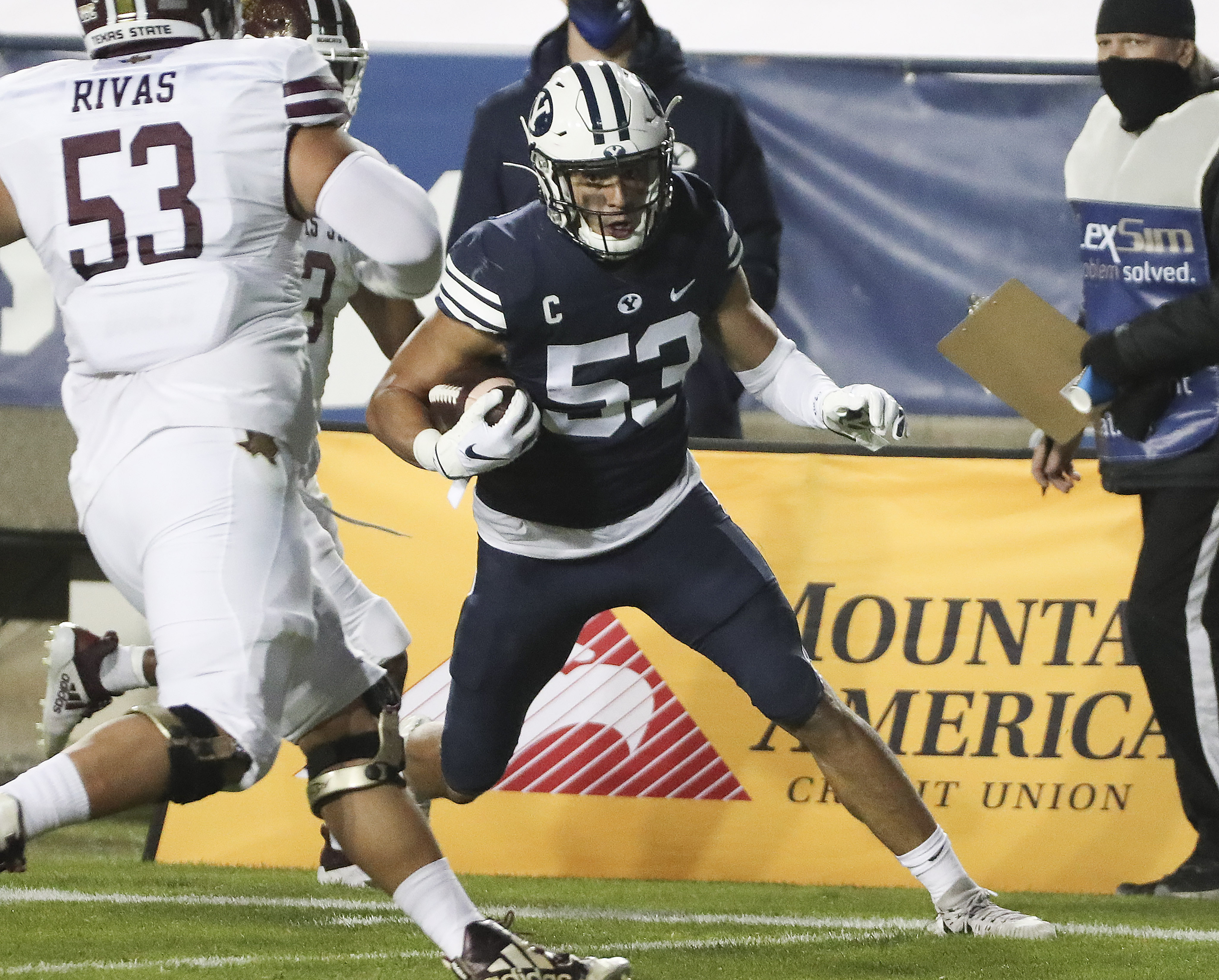Brigham Young Cougars linebacker Isaiah Kaufusi (53) intercepts the ball and runs for a touchdown in Provo on Saturday, Oct. 24, 2020.