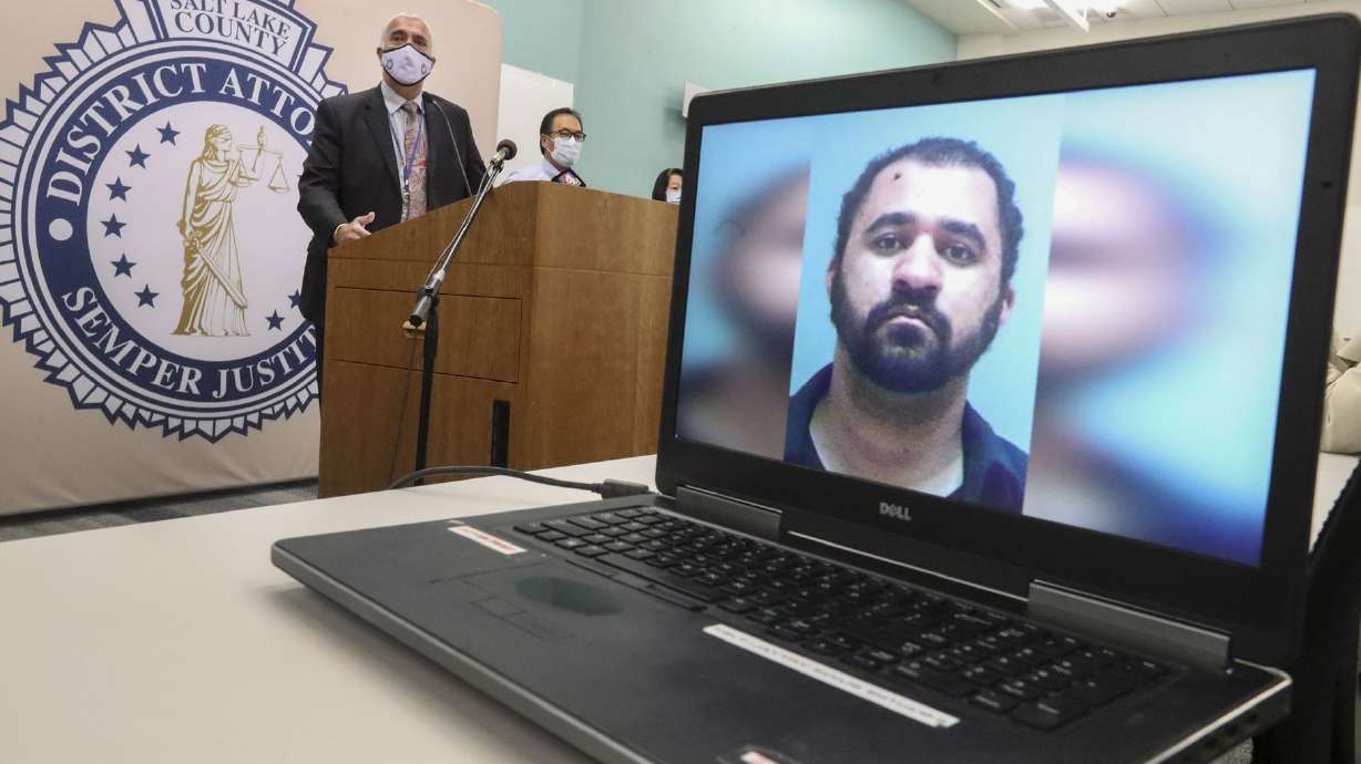 Salt Lake County District Attorney Sim Gill, left, announces aggravated murder charges against Adam Antonio Spencer Durborow, 29, of Orem, pictured on computer screen, in the 2010 death of Sherry Black on Oct. 26, 2020. On Monday, Durborow pleaded guilty to aggravated murder.