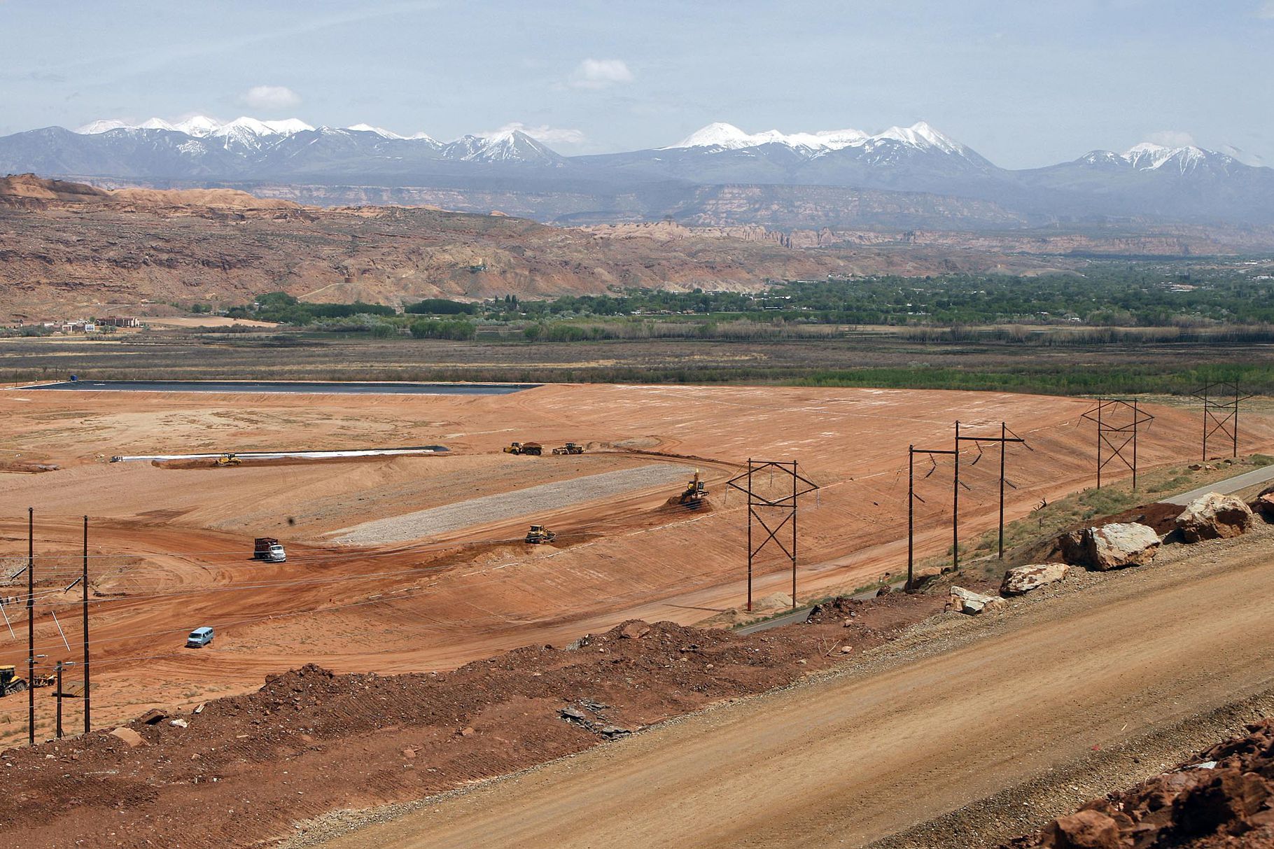 The Altas Mill uranium tailings site is pictured in 2001 with the city of Moab in the background. The radioactive tailings removal project, playing out near the banks of the Colorado River, reached another milestone with the announcement that 11 million tons of the material have safely been removed to a disposal site.