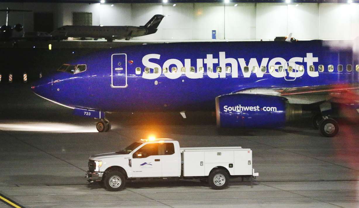 A Southwest airplane is escorted as it takes the first flight from the new Concourse B at the Salt Lake City International Airport in Salt Lake City on Tuesday, Oct. 27, 2020.