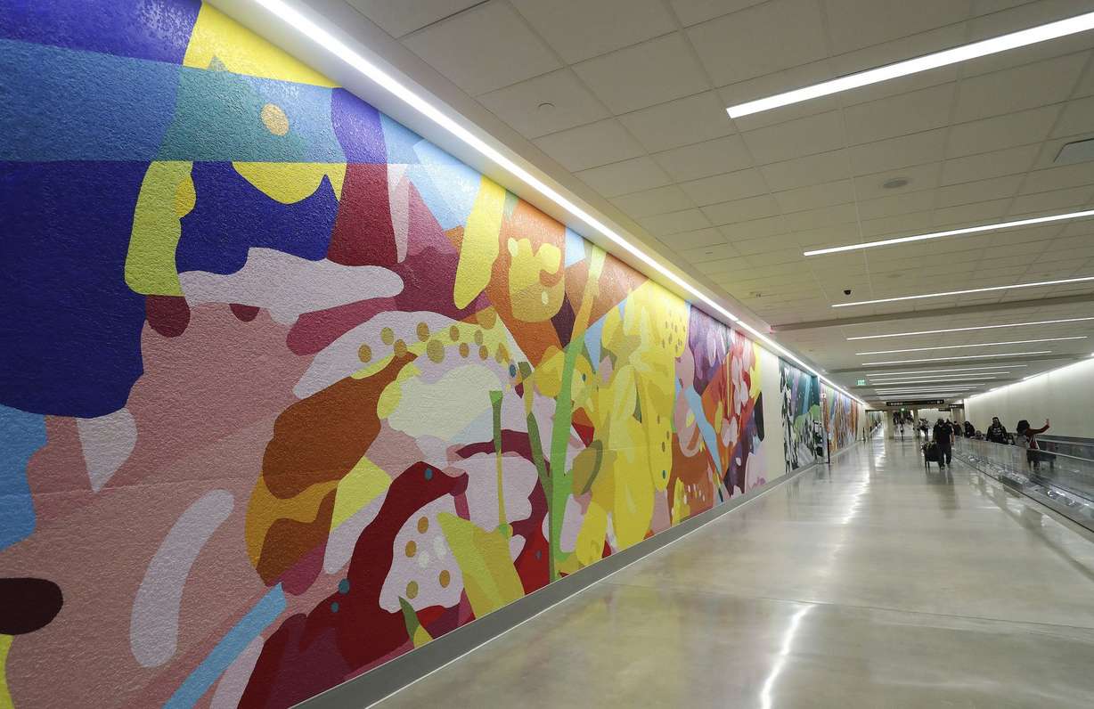 Passengers walk through a tunnel to Concourse B at the Salt Lake City International Airport in Salt Lake City on Tuesday, Oct. 27, 2020.