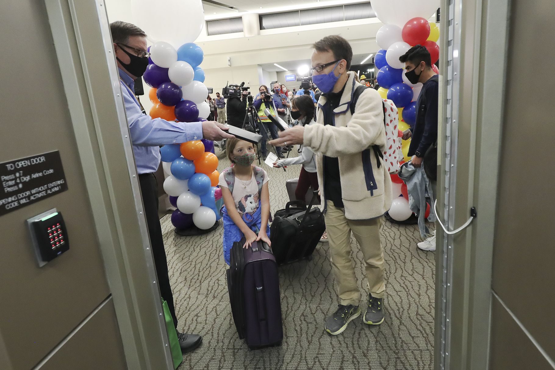 Mark Ginestro and his daughter, Anna, board the first flight out of the new Concourse B at the Salt Lake City International Airport in Salt Lake City on Tuesday, Oct. 27, 2020. Jeffrey D. Allred, Deseret News