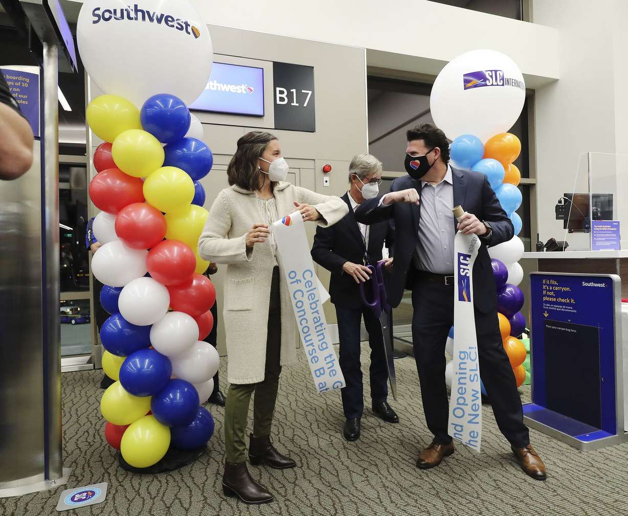 Salt Lake City Mayor Erin Mendenhall, left, Bill Wyatt, executive director of the Salt Lake City Department of Airports, and Steve Sisneros, managing director of airport affairs for Southwest Airlines, cut the ribbon as Concourse B opens and Southwest Airlines take the first flight at the Salt Lake City International Airport in Salt Lake City on Tuesday, Oct. 27, 2020.