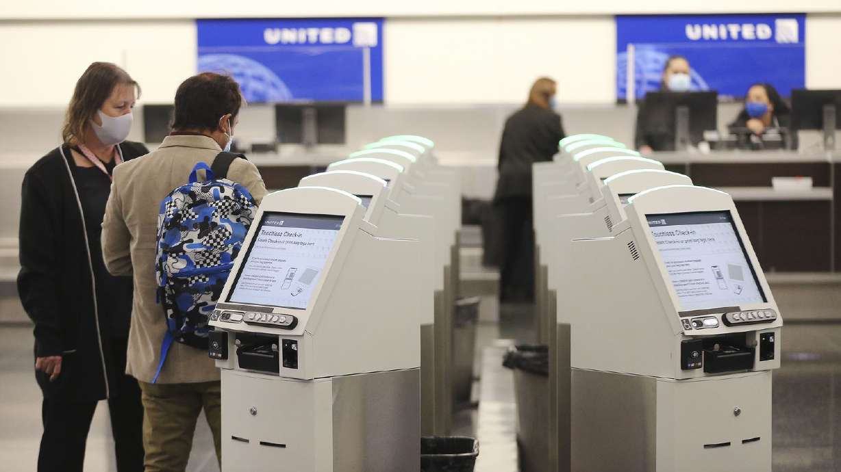Passengers check in at United Airlines as Concourse B opens at the Salt Lake City International Airport in Salt Lake City on Tuesday, Oct. 27, 2020.