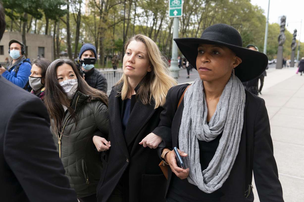 Linda Chung, left, Nicki Clyne, center, and Michelle Hatchette leave Brooklyn federal court following the sentencing hearing for self-improvement guru Keith Raniere, Tuesday, Oct. 27, 2020 in New York. Raniere, the NXIVM leader, was sentenced to 120 years.