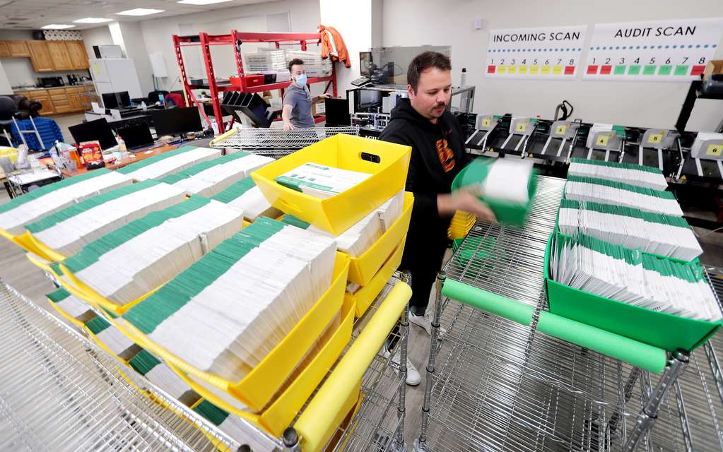 Election ballots are processed by workers at the Utah County Clerk/Auditor's Office in Provo on Tuesday, Oct. 27, 2020.