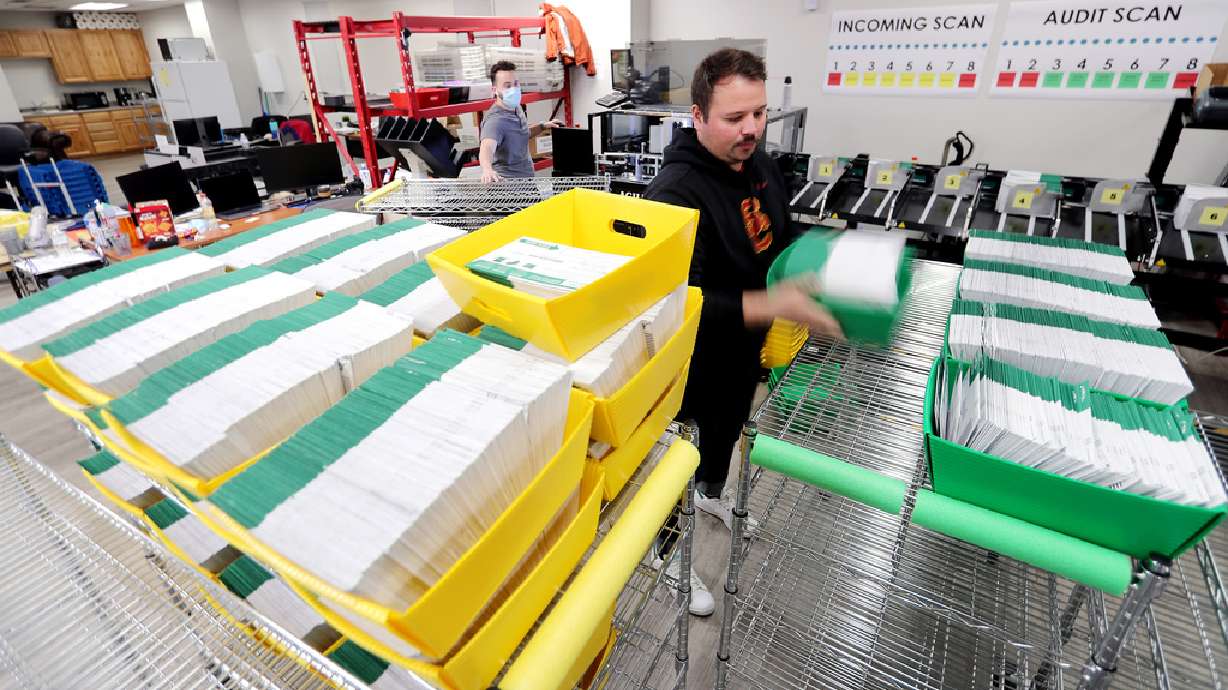 Election ballots are processed by workers at the Utah County Clerk/Auditorâ??s Office in Provo on Tuesday, Oct. 27, 2020.