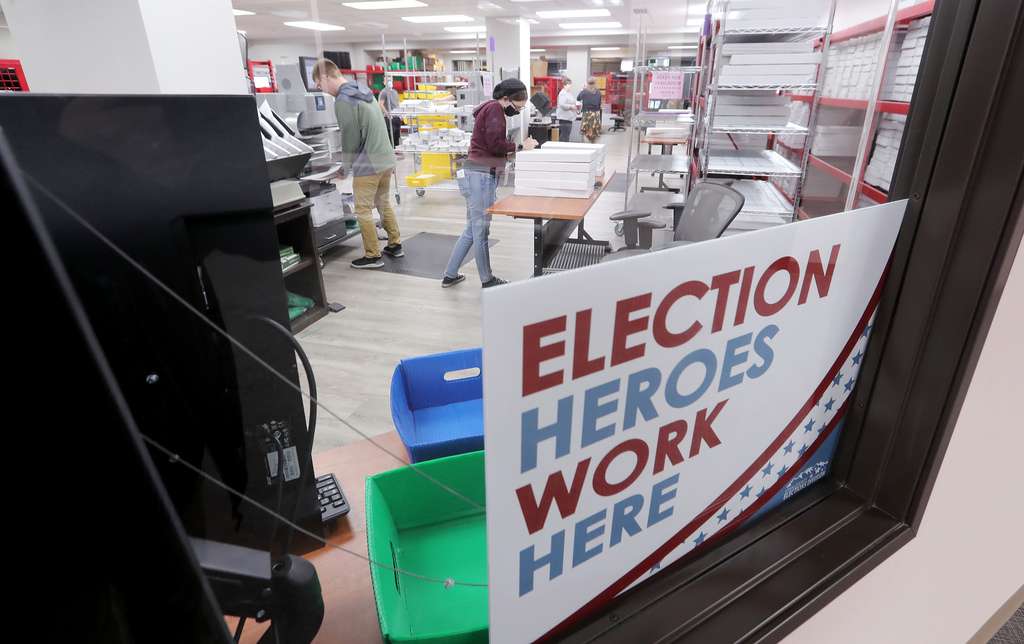Jordan Carbine and Alex Priest enter ballots into the system at the Utah County Clerk/Auditor's Office in Provo on Tuesday, Oct. 27, 2020.