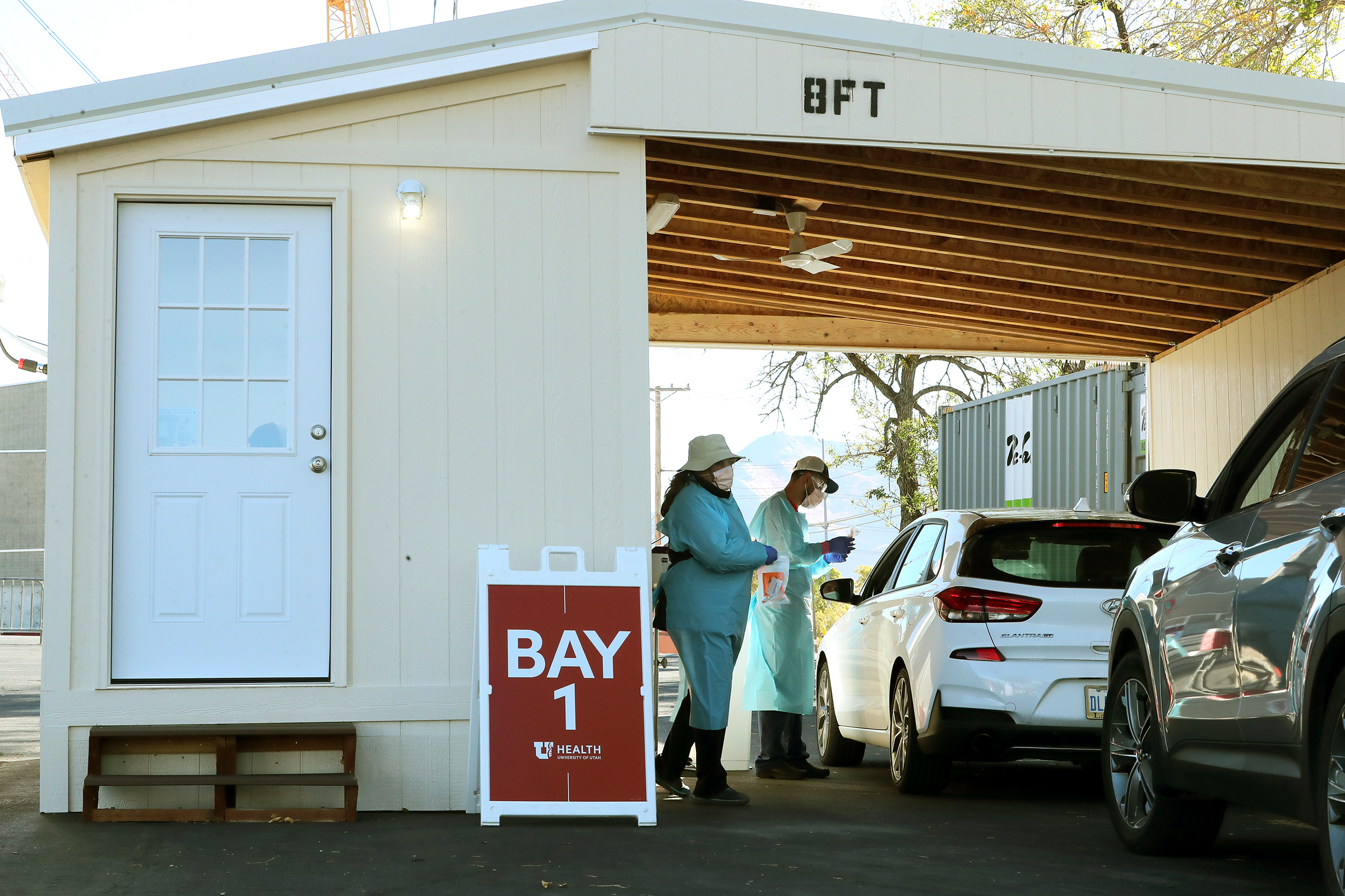 Nurses Polly Crookston and Daniel Salas Jimenez work at a new COVID-19 testing site in the parking lot of Rice-Eccles Stadium in Salt Lake City on Monday, Oct. 12, 2020. The testing site is open Monday through Friday, 8 a.m. to 4 p.m., and Saturday and Sunday, 8 a.m. to noon. Appointments are required.