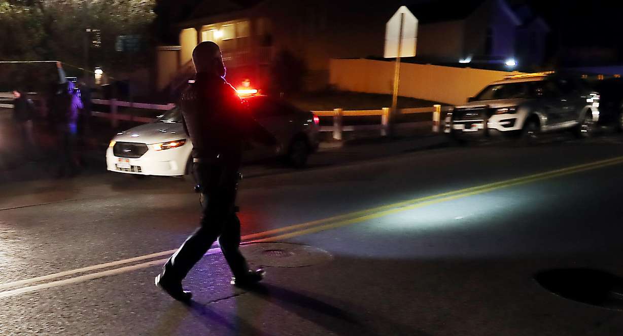 A Unified police officer walks in the street motioning to traffic at the scene of a domestic violence homicide at 115 W. Settlement Circle In Midvale on Wednesday, Oct. 28, 2020.