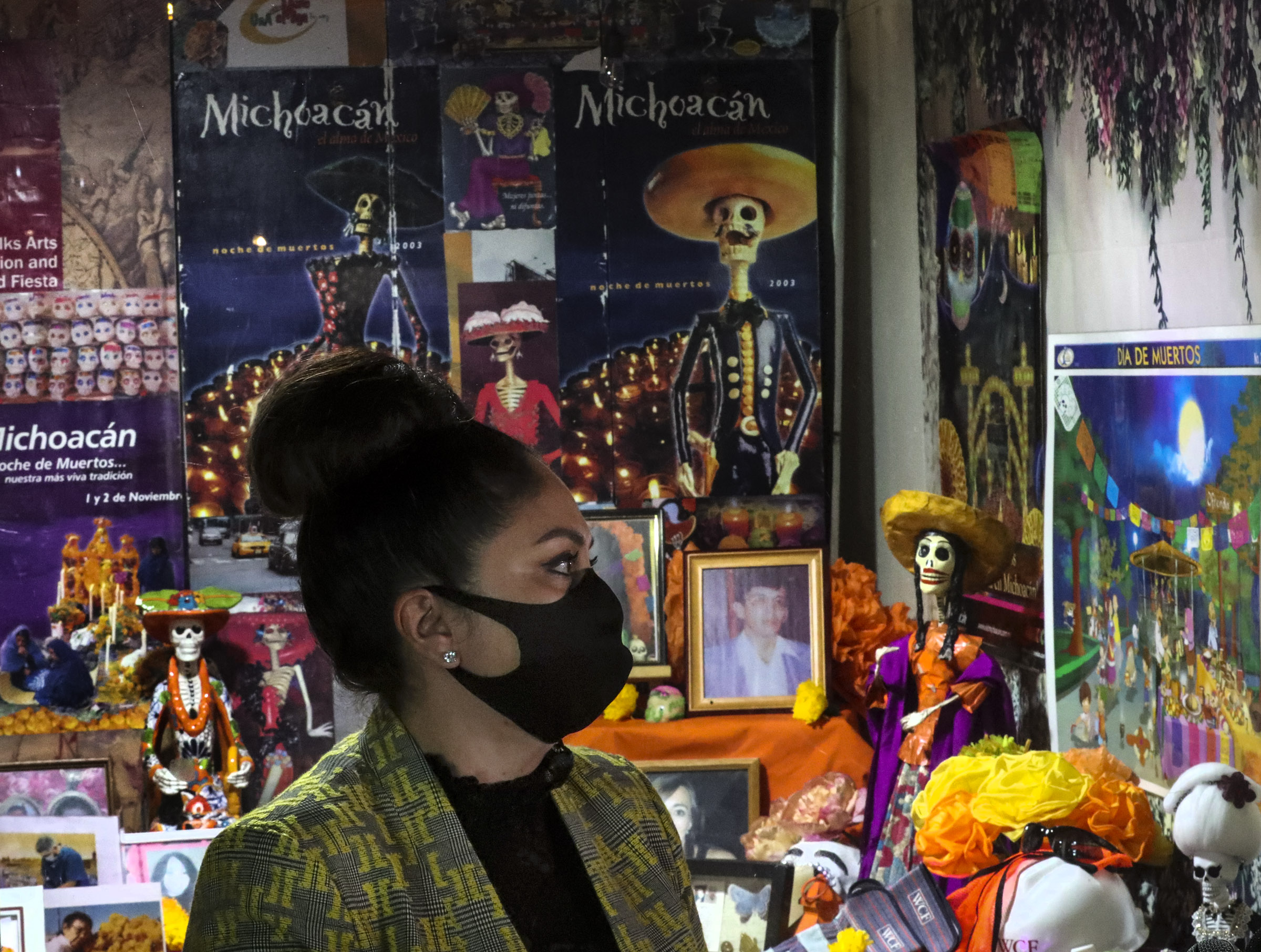 Artist Marla O. Lepe talks about her family and friends who have died and are represented in Una Mano Amiga’s Day of the Dead window display, pictured behind her, during a press conference at Trolley Square in Salt Lake City on Wednesday, Oct. 28, 2020. This year, because of COVID-19, the organization designed the special social distancing window honoring family members, friends, first responders and others who died of the virus.