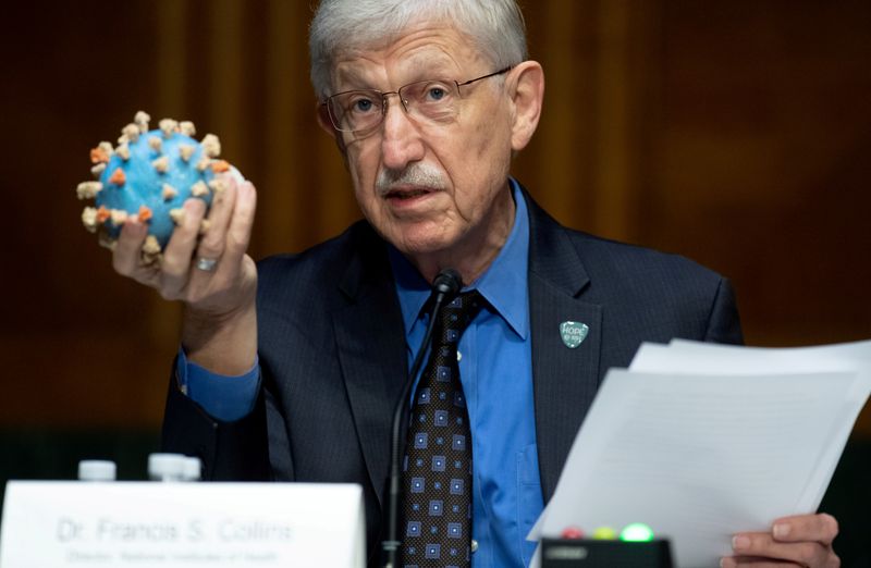 FILE PHOTO: Dr Francis Collins, Director of the National Institutes of Health (NIH), holds up a model of SARS-CoV-2, known as the novel coronavirus,  during a U.S. Senate Appropriations Subcommittee Hearing on the plan to research, manufacture and distribute a coronavirus vaccine, known as Operation Warp Speed on Capitol Hill in Washington, D.C, U.S., July 2, 2020.