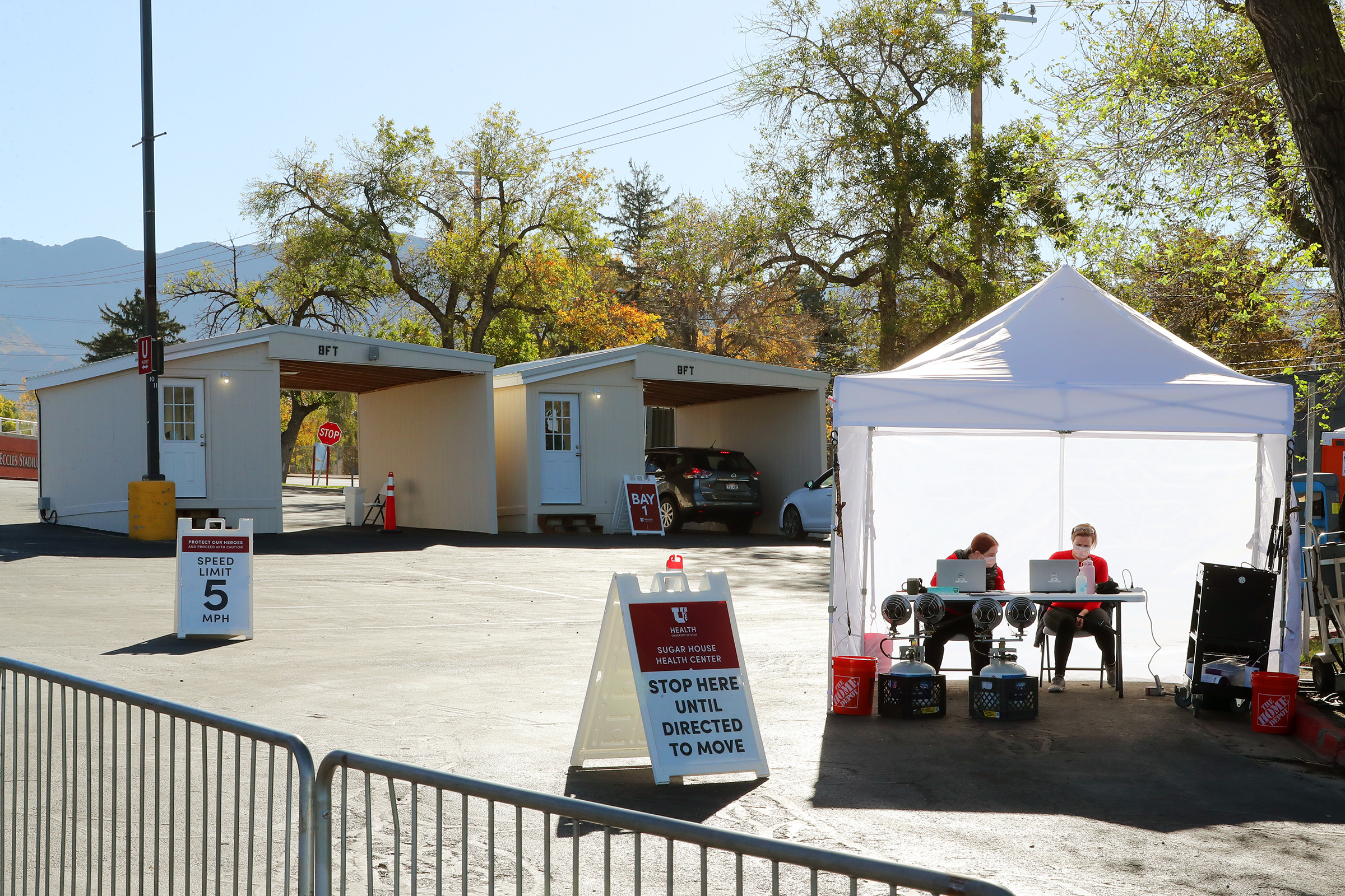 Health care workers work at a new COVID-19 testing site in the parking lot of Rice-Eccles Stadium in Salt Lake City on Monday, Oct. 12, 2020. The testing site is open Monday through Friday, 8 a.m. to 4 p.m., and Saturday and Sunday, 8 a.m. to noon. Appointments are required.