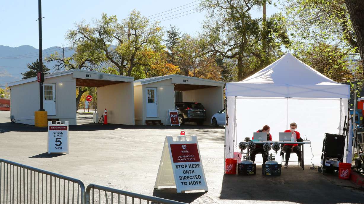 Health care workers work at a new COVID-19 testing site in the parking lot of Rice-Eccles Stadium in Salt Lake City on Monday, Oct. 12, 2020. The testing site is open Monday through Friday, 8 a.m. to 4 p.m., and Saturday and Sunday, 8 a.m. to noon. Appointments are required.