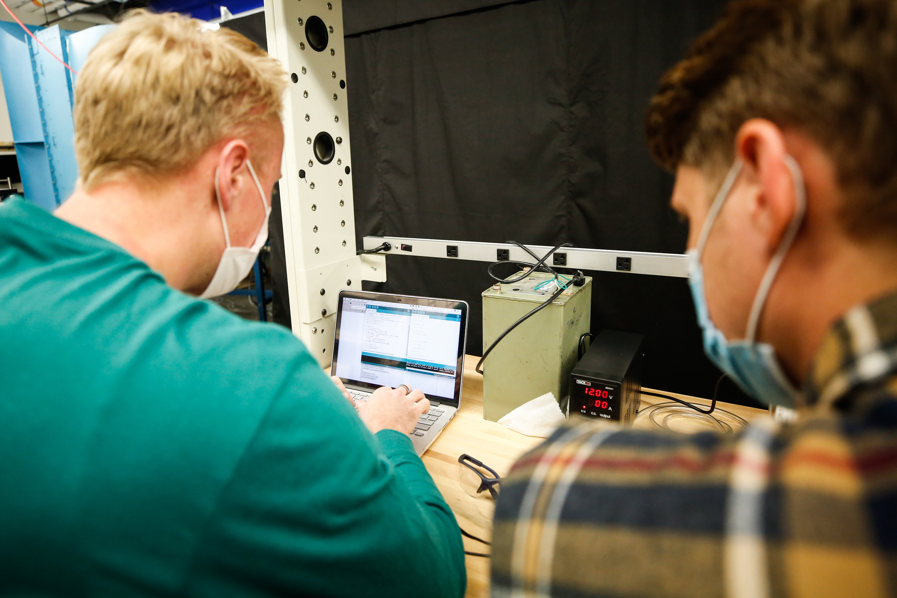Spencer Curtis, left, works on a computer program for an electrical spinning machine with group partner Denton Markwalter in the engineering resource lab at BYU in Provo on Monday, Oct. 26, 2020. The machine can be used to spin a nanofiber membrane that can be sandwiched between the cloth pieces of a homemade mask, increasing effectiveness while preserving breathability.