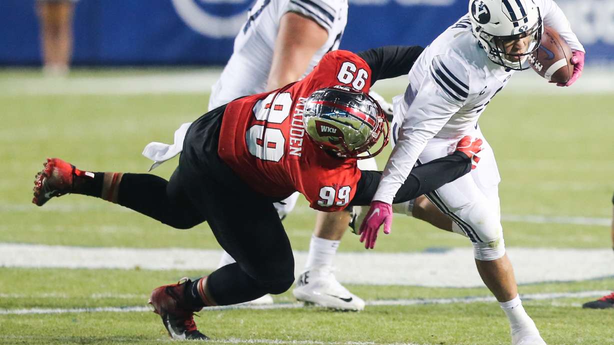 Brigham Young Cougars running back Lopini Katoa (4) carries the ball against the Western Kentucky Hilltoppers defense during an NCAA football game at LaVell Edwards Stadium in Provo on Saturday, Oct. 31, 2020.