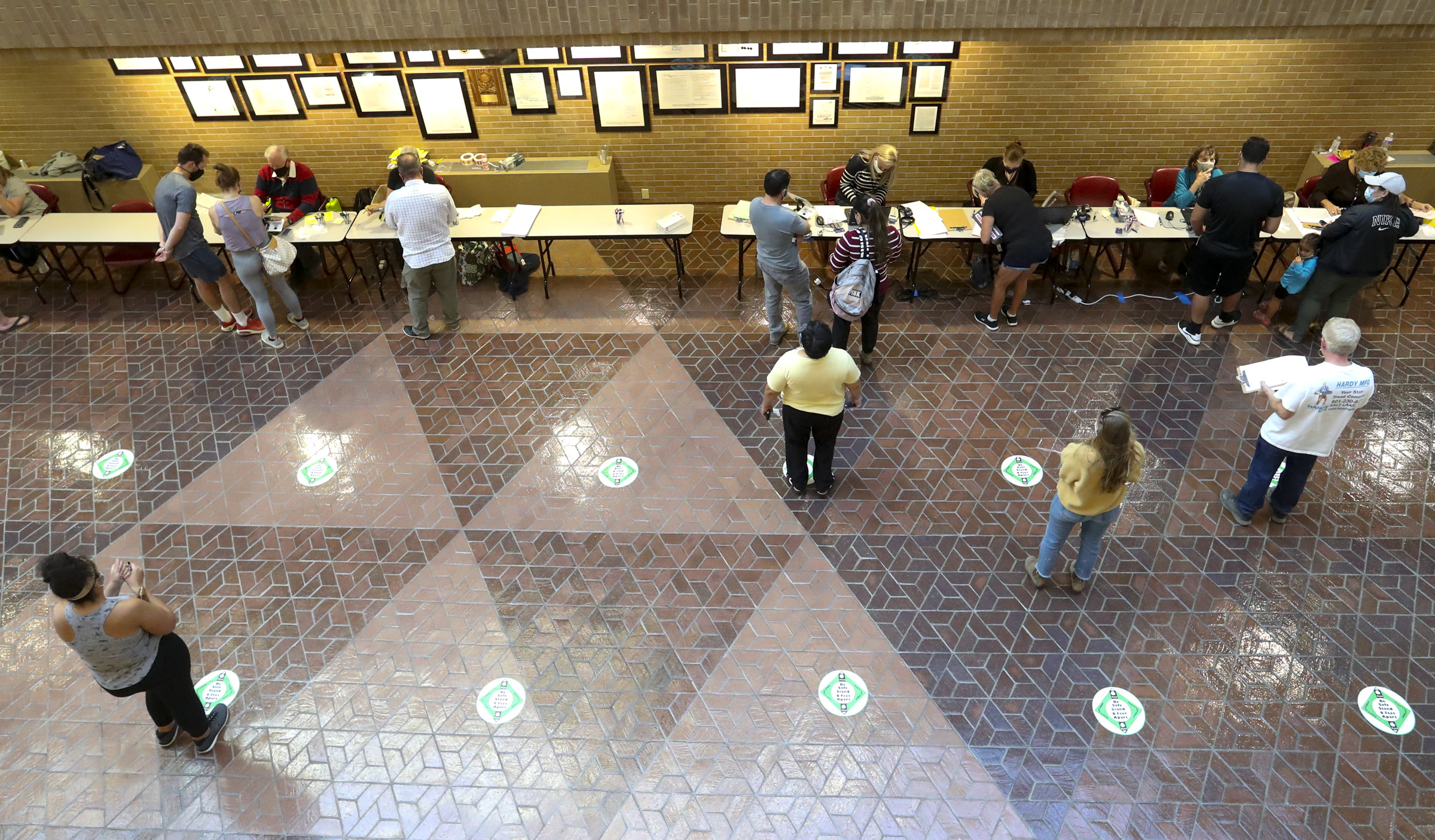 People check in and register to vote in person at the Salt Lake County Government Center on Oct. 20, 2020. Voters headed to the polls Tuesday for Utah's primary election.
