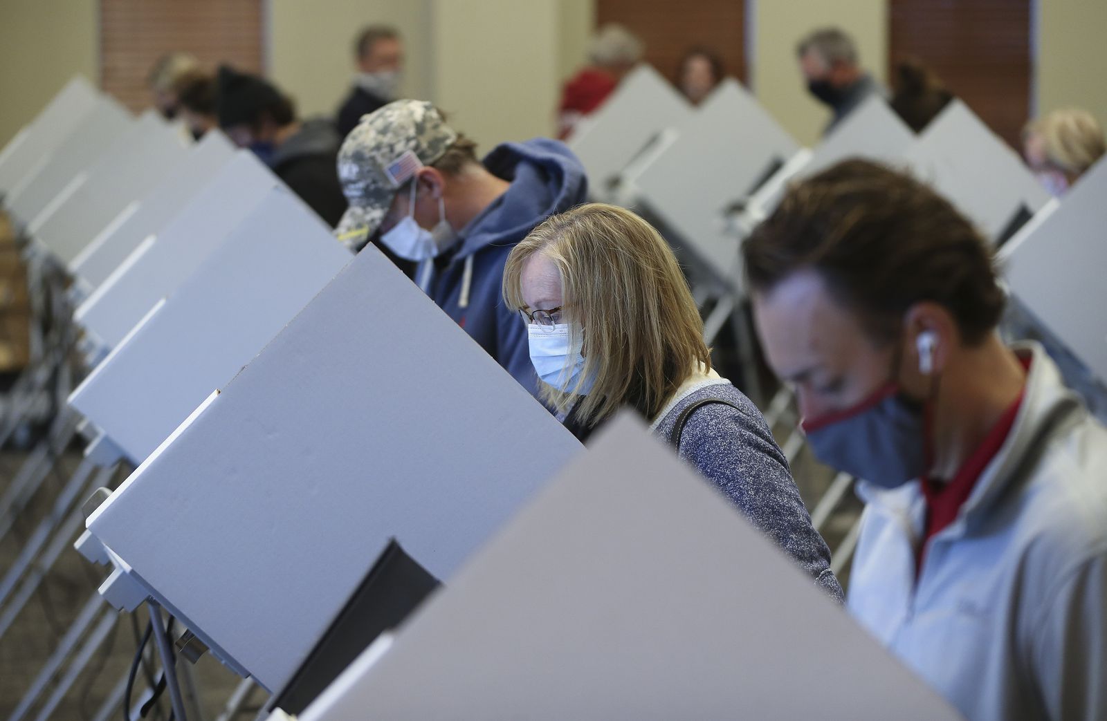 Jeanna Henderson, second from right, votes at Draper City Hall in Draper on Tuesday, Nov. 3, 2020.