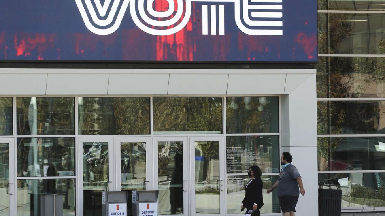 A couple walk up to Vivint SmartHome Arena to vote in Salt Lake City on Tuesday, Nov. 3, 2020.