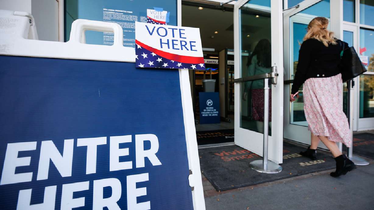 Voters walk into the gate of Vivint SmartHome Arena during the Election Day voting in Salt Lake City on Tuesday, Nov. 3, 2020.