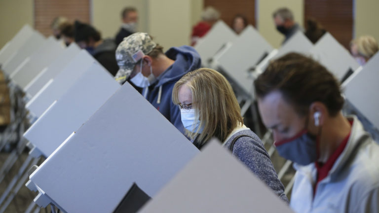Jeanna Henderson, second from right, votes at Draper City Hall in Draper on Tuesday, Nov. 3, 2020.