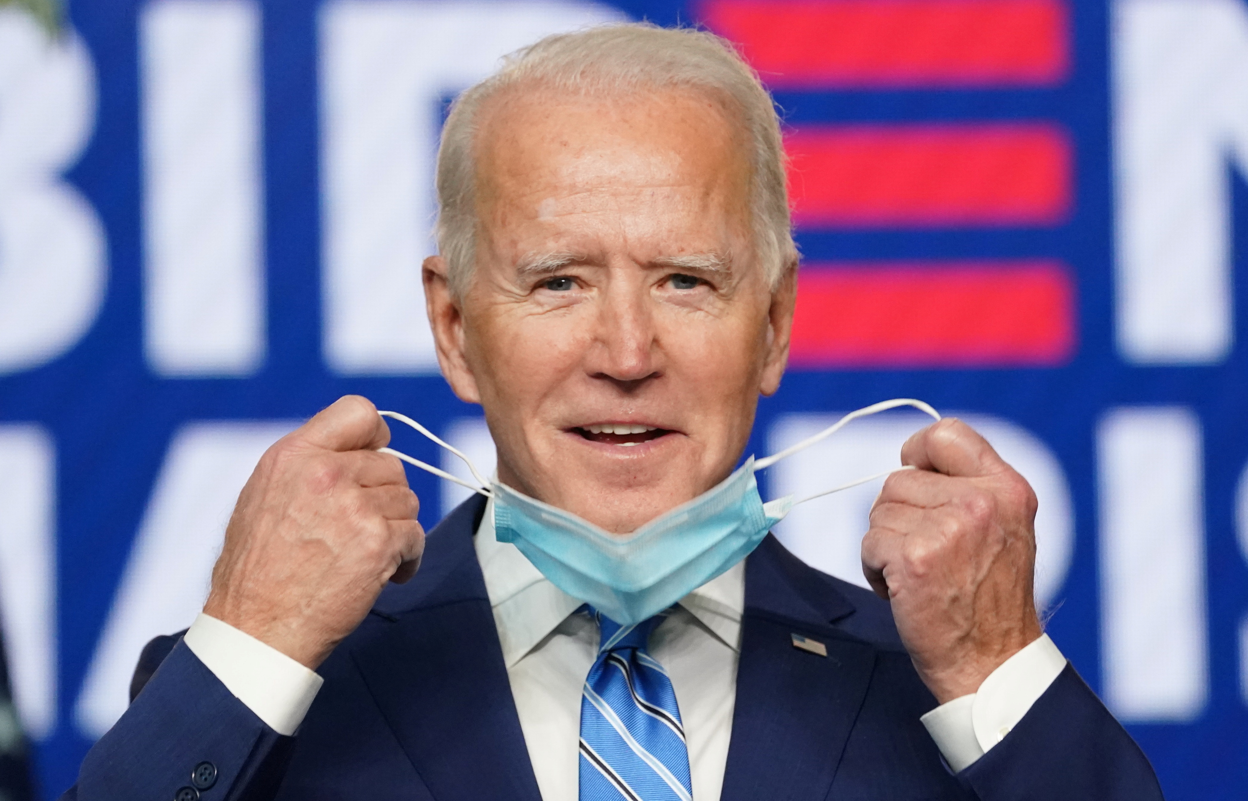 Democratic U.S. presidential nominee Joe Biden smiles as he takes off his mask to speak about the voting results of the 2020 U.S. presidential election during an appearance in Wilmington, Delaware, U.S., November 4, 2020.