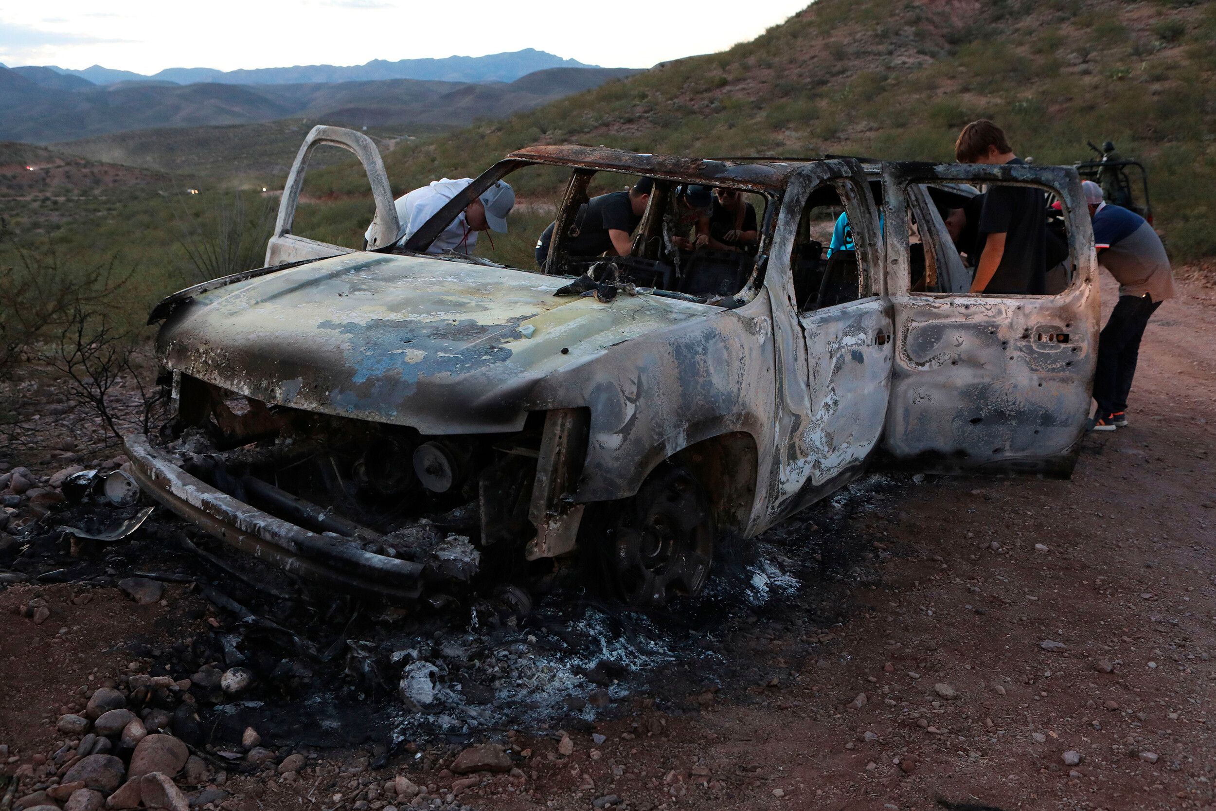 A man has been arrested in connection with last year's massacre of nine Mormon American-Mexican citizens on a remote dirt road in northwestern Mexico, officials in that country said. In this photo, relatives of the slain examine one of the three vehicles that were attacked in Mexico's Sonora state.