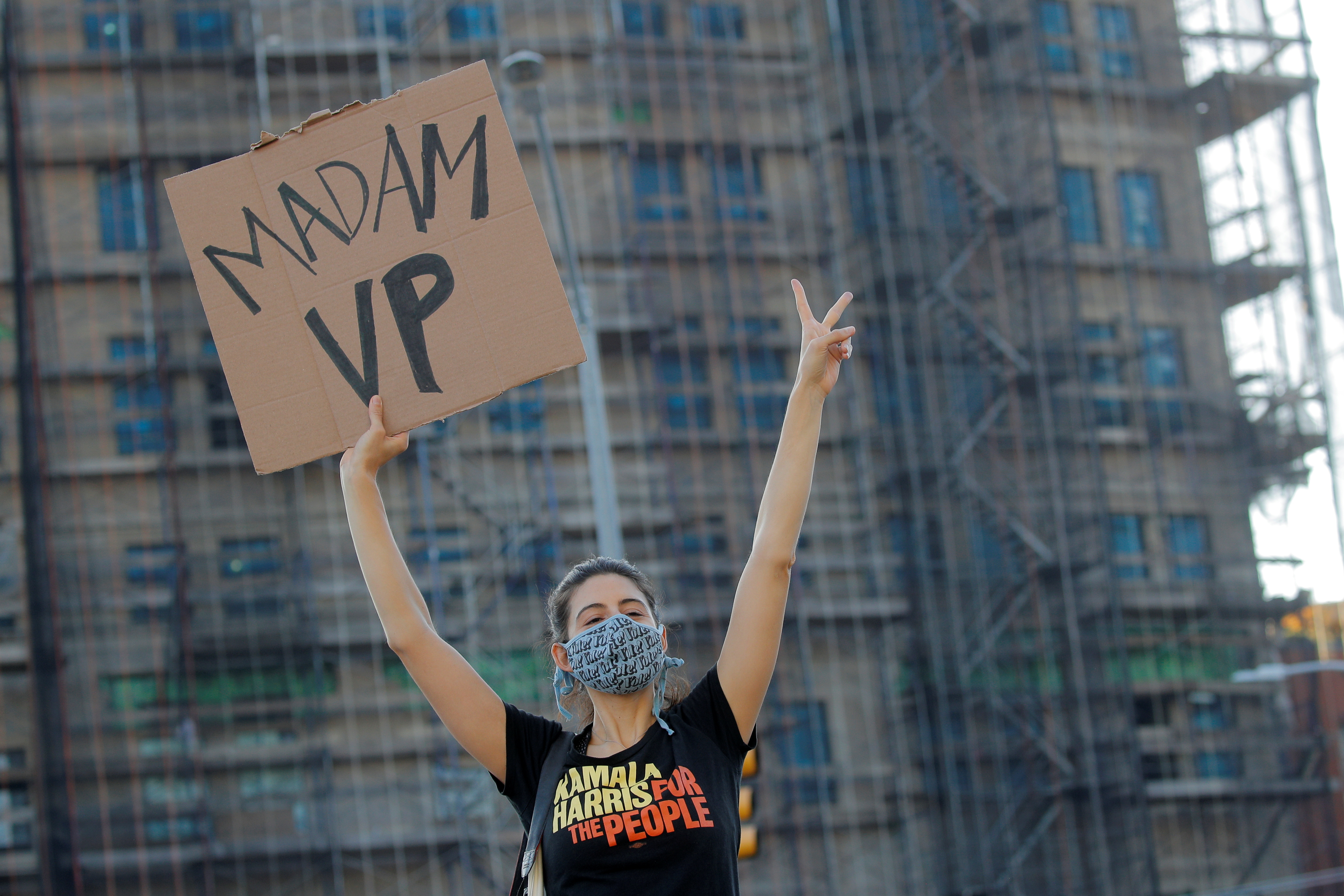 A woman holds a sign as people celebrate after media announced that Democratic U.S. presidential nominee Joe Biden has won the 2020 U.S. presidential election, in the Brooklyn borough of New York City, New York, U.S., November 7, 2020.