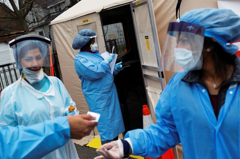 FILE PHOTO: Phlebotomists stand outside a triage testing area for the coronavirus disease (COVID-19) at Roseland Community Hospital on the South Side of Chicago, Illinois, U.S., April 22, 2020.  REUTERS/Shannon Stapleton