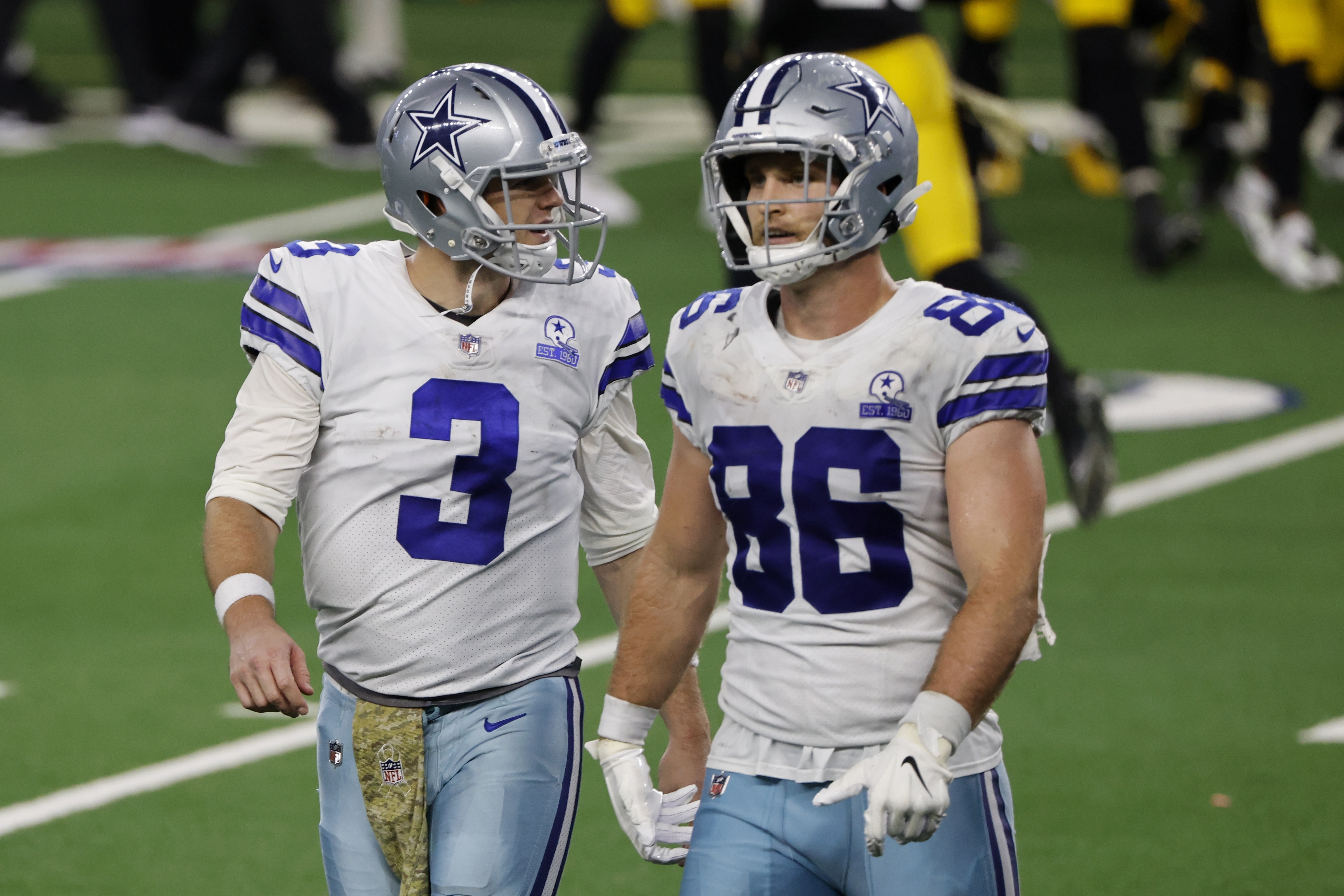Dallas Cowboys' Garrett Gilbert (3) and Dalton Schultz (86) walk to the sideline after a pass by Gilbert was intercepted by Pittsburgh Steelers' Minkah Fitzpatrick in the end zone in the second half of an NFL football game in Arlington, Texas, Sunday, Nov. 8, 2020.