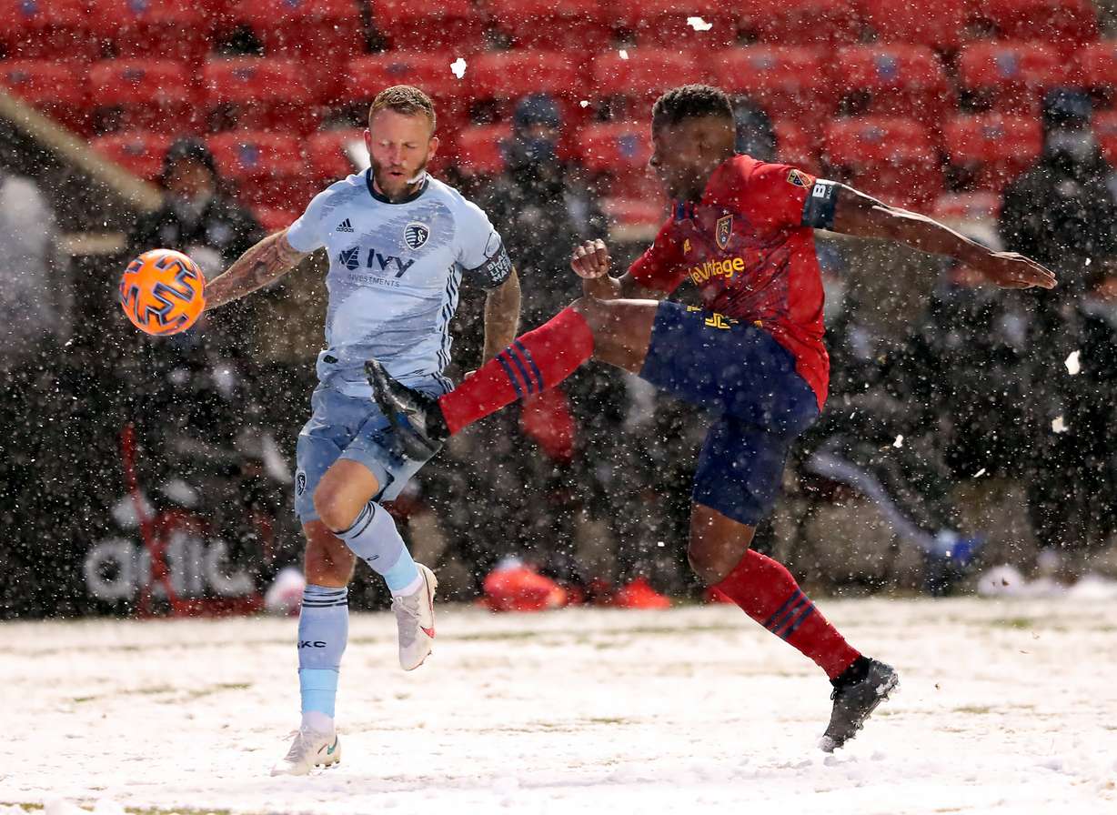 Sporting Kansas City forward Johnny Russell (7) and Real Salt Lake defender Nedum Onuoha (14) battle for the ball as Real Salt Lake and Sporting KC play at Rio Tinto Stadium in Sandy on Sunday, Nov. 8, 2020.