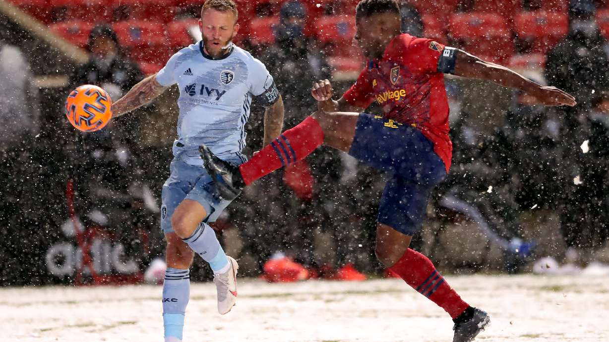 Sporting Kansas City forward Johnny Russell (7) and Real Salt Lake defender Nedum Onuoha (14) battle for the ball at Rio Tinto Stadium, Nov. 8, 2020. Russell scored the only goal of the match to hand RSL its first loss of the season.