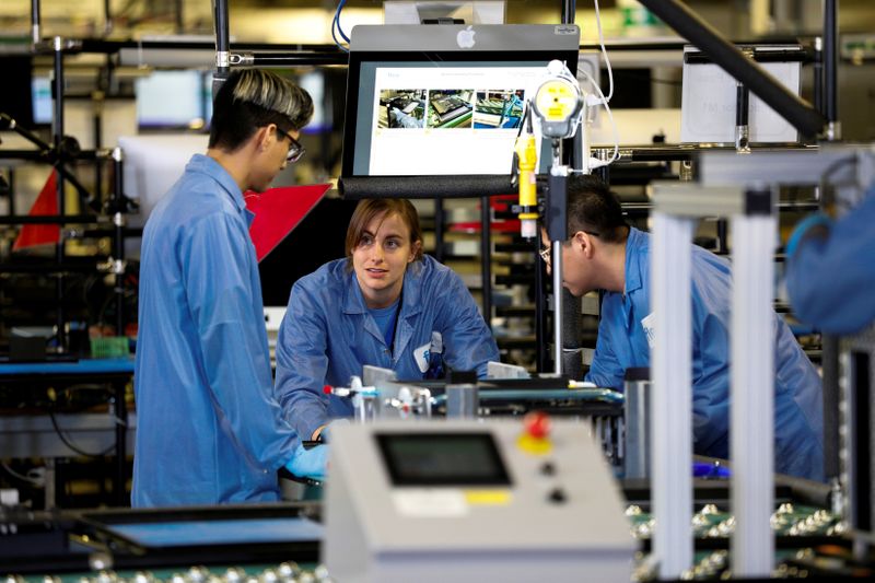 FILE PHOTO: Flextronics International Apple factory employees work on Apple Mac Pro computer assembly in Austin, TX, U.S., November 20, 2019. REUTERS/Tom Brenner