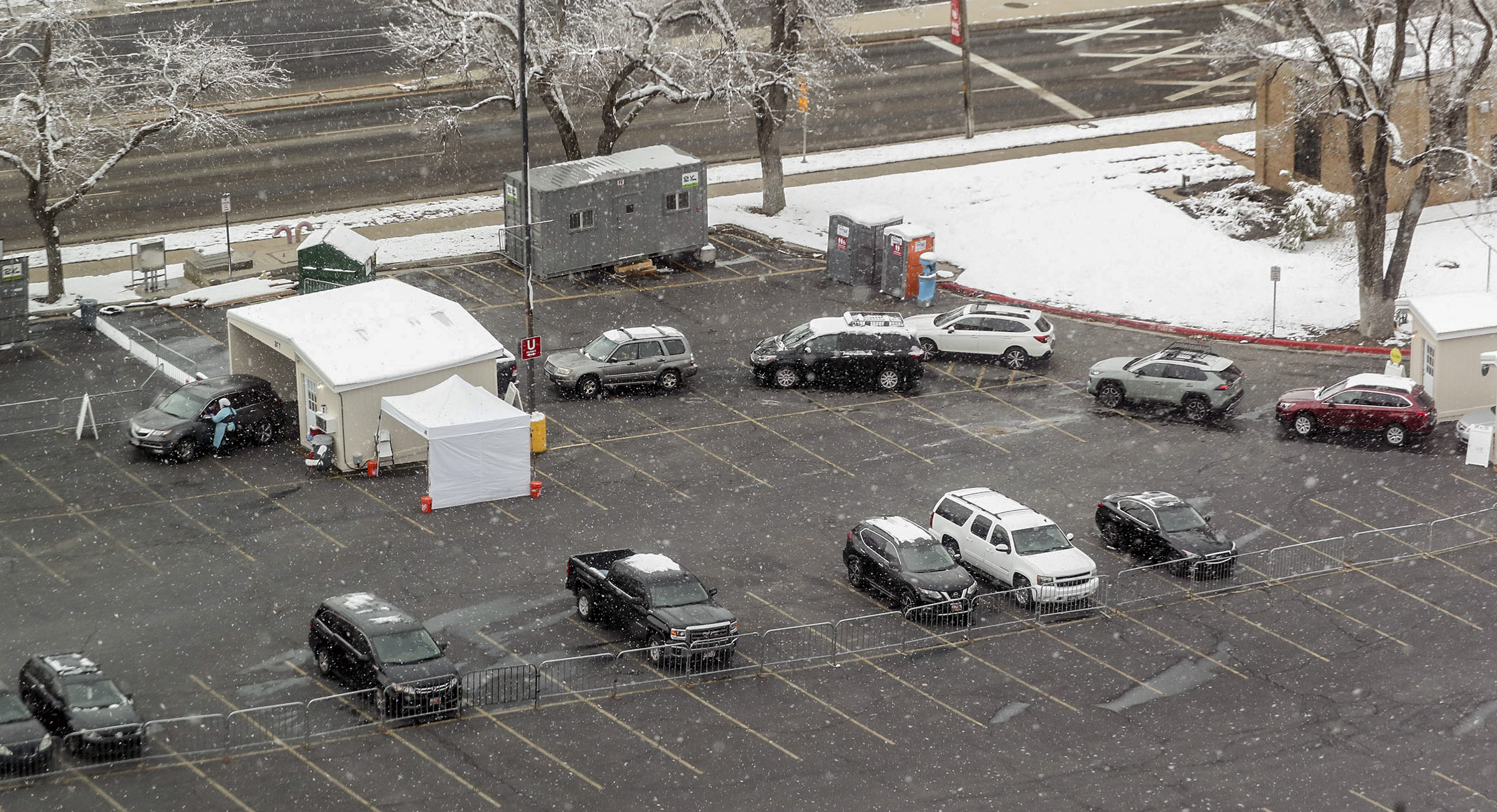 People wait in line to be tested at the University of Utah Health’s COVID-19 testing site at Rice-Eccles Stadium at the University of Utah in Salt Lake City on Monday, Nov. 9, 2020. The test site is open again after a truck crashed into the testing station last week, injuring nine people.The site will remain open during the winter even though University of Utah Health will move most of its operation indoors.