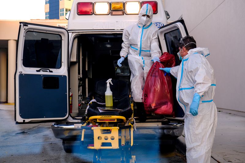 FILE PHOTO: EMTs cleanse their materials outside Memorial West Hospital where coronavirus disease (COVID-19) patients are treated, in Pembroke Pines, Florida, U.S. July 13, 2020. REUTERS/Maria Alejandra Cardona/File Photo