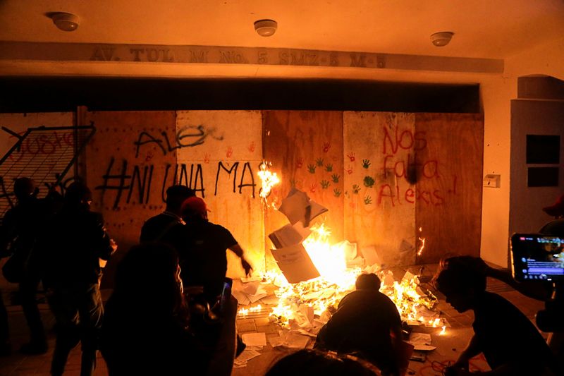 Demonstrators burn documents while vandalizing the Municipal Palace during a protest to demand justice for the murder of Blanca Alejandrina, known as Alexis, which was disbanded by the police with shots into the air to disperse demonstrators who were vandalizing the government premises, in Cancun, Mexico November 9, 2020. REUTERS/Israel Leal