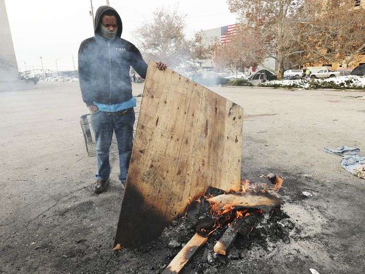 Tyrell Morris, who is homeless, tends a fire for warmth on 700 South in Salt Lake City on Tuesday, Nov. 10, 2020.