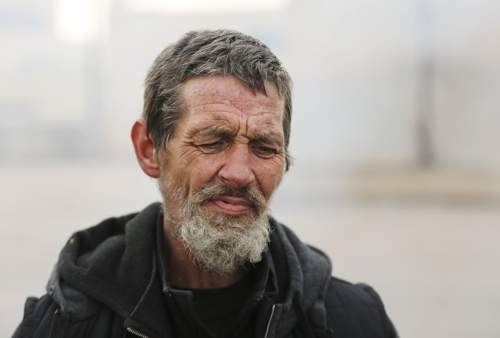 Brandon Stephens watches a fire near his shelter on 700 South in Salt Lake City on Tuesday, Nov. 10, 2020.