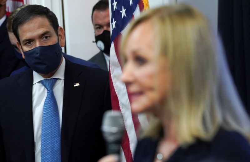 U.S. Senator Marco Rubio listens as Senator David Perdue's wife, Bonnie Perdue, speaks during an event at the Cobb County Republican Party headquarters, in Marietta, Georgia, U.S., November 11, 2020. REUTERS/Elijah Nouvelage