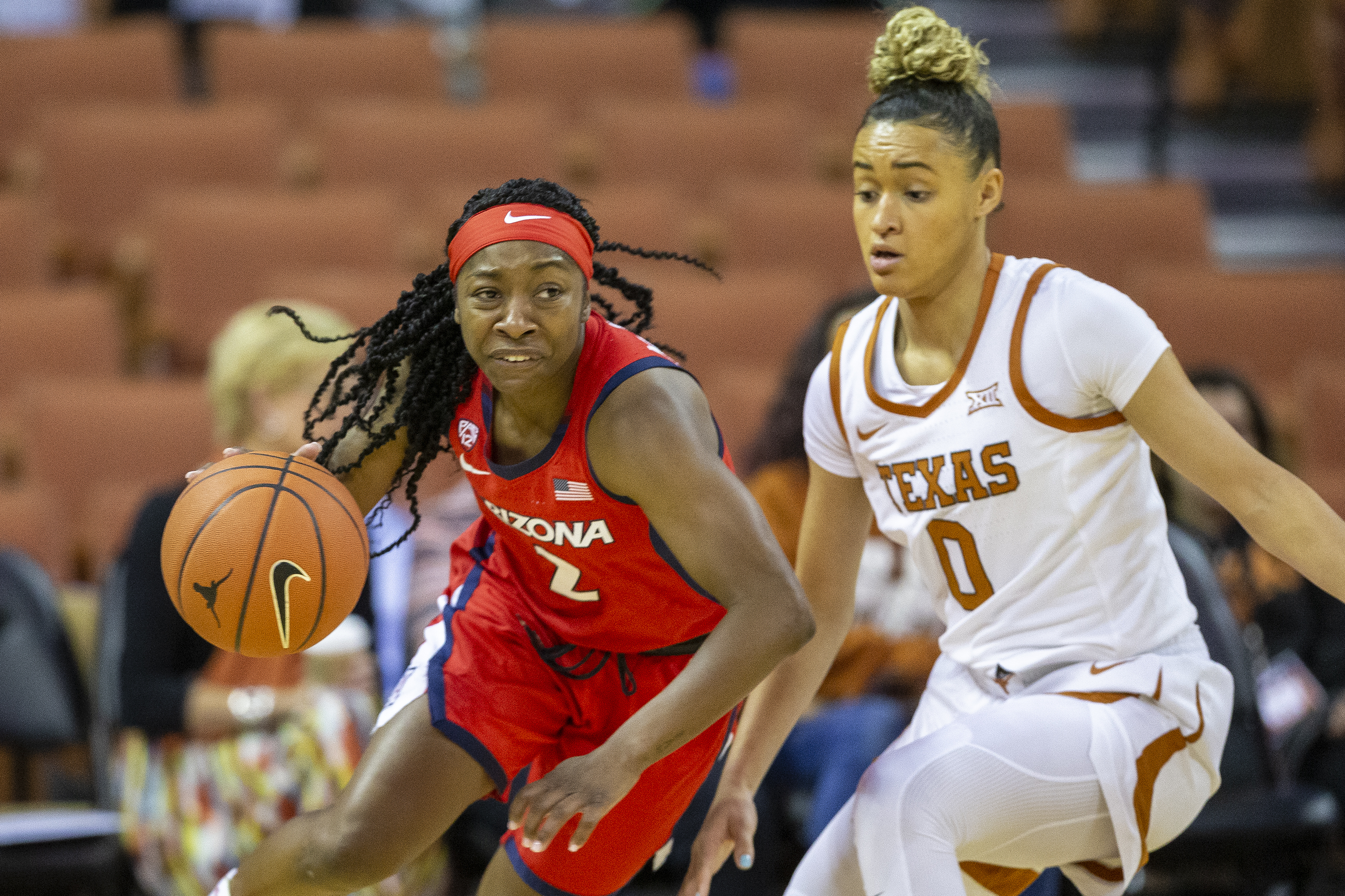 In this Nov. 17, 2019, file photo, Arizona guard Aari McDonald (2) drives around Texas guard Celeste Taylor (0) during an NCAA college basketball game in Austin, Texas. McDonald and the No. 3-seeded Wildcats will face 11th-seeded BYU in an NCAA second-round game Wednesday at 5 p.m. MDT.