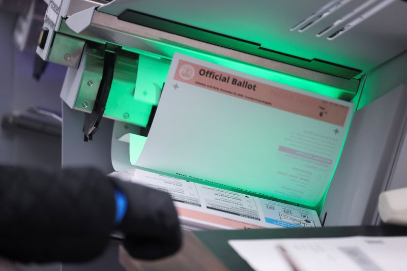A person counts postal ballots following the 2020 U.S. presidential election, in Downey, near Los Angeles, California, U.S., November 5, 2020. REUTERS/Lucy Nicholson
