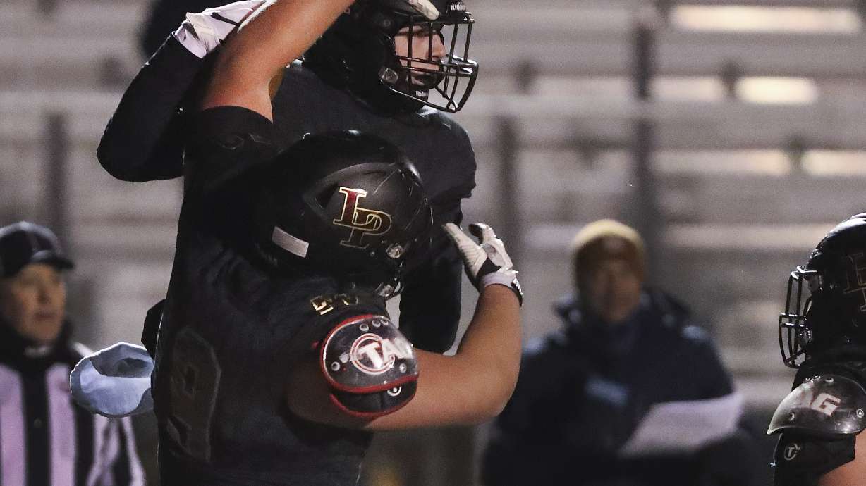 Lone Peak's Luke Tucker (20) celebrates his touchdown catch with Joe Brown (79) against Skyridge in a 6A semifinal football game in Eagle Mountain on Thursday, Nov. 12, 2020.