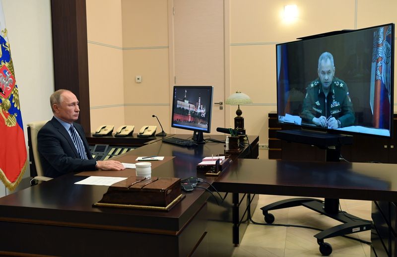 Russian President Vladimir Putin speaks with Defence Minister Sergei Shoigu during a meeting dedicated to a humanitarian mission in the region of Nagorno-Karabakh via a video conference call at the Novo-Ogaryovo state residence outside Moscow, Russia November 13, 2020. Sputnik/Aleksey Nikolskyi/Kremlin via REUTERS