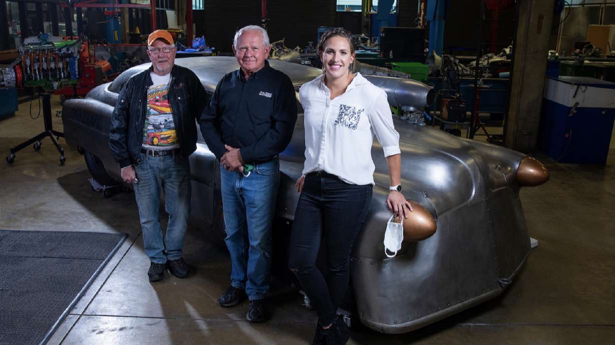 Danielle Cash (right), and Don Cash, Sr.,(center), the father and daughter of Don Cash, Jr., stand next to UVU Transportation Technology professional in residence Jeff Holm (left) in front of "Bombshell Betty" in an undated photo. Don Cash, Jr. owned the car up until his death in 2019. UVU students are now working to repair the vehicle.