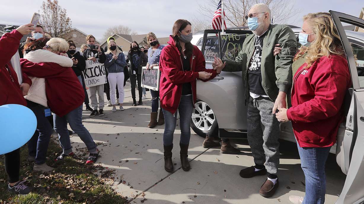Vietnam veteran Warren Craig Eby, right center, is assisted by daughters Alissa Allen, left, and Lauren Cooper, right, during a welcome home celebration in Saratoga Springs on Friday, Nov. 13, 2020. Eby was hospitalized for seven weeks with COVID-19. At far left, Eby's wife, Sandra, hugs their niece Cindy Lampropoulos.