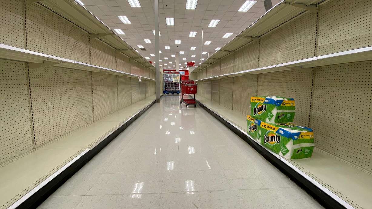 A few packages of paper towels are all that remain on shelves at a Target in Sandy on Tuesday April 14, 2020. Grocery and warehouse stores are hoping to avoid the hoarding of certain household items that took place last spring.