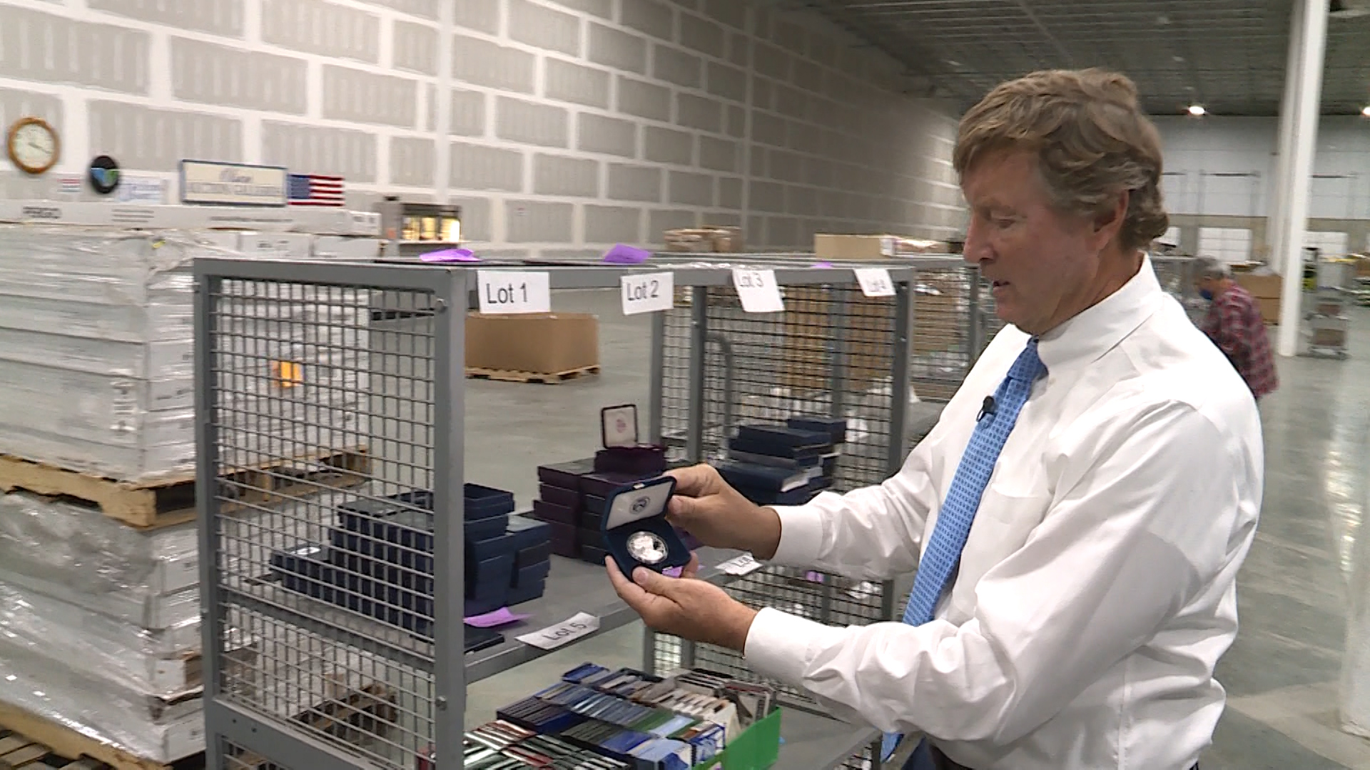 Rob Olson, owner of Erkelens & Olson Auctioneers, prepares coins for auction in Salt Lake City on Saturday, Nov. 14, 2020. The coins, from the Rust Rare Coin company, are being sold to help pay back victims of a Ponzi scheme that federal prosecutors say was being run by the family that owned Rust Rare Coin.