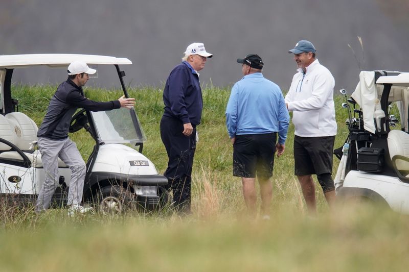 U.S. President Donald Trump greets golfers during his round of play at the Trump National Golf Club in Sterling, Virginia, U.S., November 15, 2020.      REUTERS/Joshua Roberts